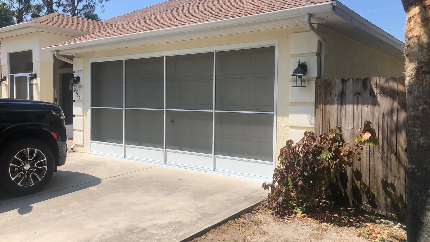 Sliding garage screen door installed across a two car garage opening in Sarasota