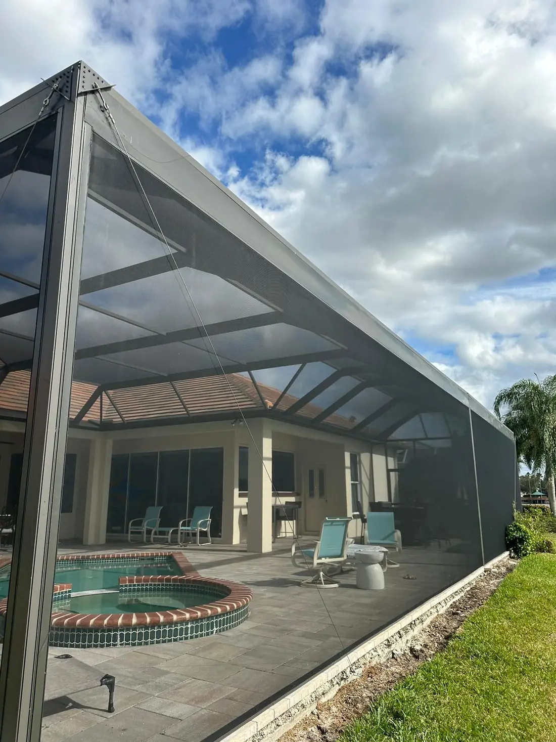 Panoramic screen enclosure with tall uninterrupted screen panels facing a lake in Sarasota